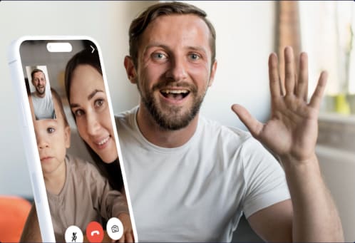 Man similing and waving at his family on a video call