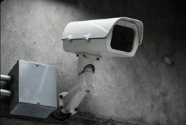 Video surveillance camera on a wall